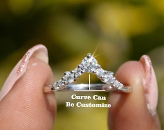 May include: A silver ring with a curved band of small diamonds. The curve of the band can be customized. "Curve Can Be Customize" is written below the ring.