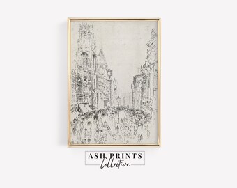 May include: A framed black and white sketch print depicting a busy city street scene with tall buildings, numerous pedestrians, and horse-drawn carriages. The artwork is enclosed in a thin gold-colored frame and features a light off-white background.
