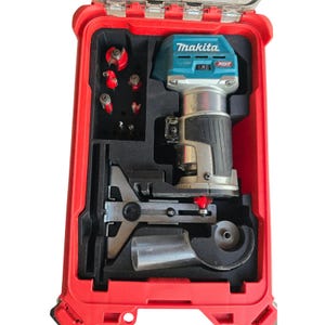 May include: A red plastic case containing a blue and black Makita XGT router and various bits. The case has a handle on the top and a latch on the front.