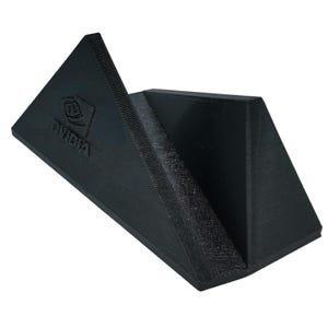 May include: A black plastic stand with a triangular shape and the NVIDIA logo printed on the front. The stand is designed to hold a graphics card.
