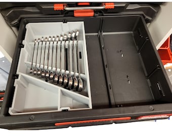 May include: Open toolbox drawer with a set of shiny, silver wrenches neatly arranged in a gray organizer. The drawer is black with orange accents, suggesting a durable and organized storage solution for tools.