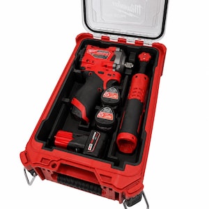 May include: A red Milwaukee Packout storage case containing a red and black cordless impact wrench, a red and black cordless ratchet, and two M12 Redlithium batteries. The case features a clear lid with the Milwaukee logo printed on the top.