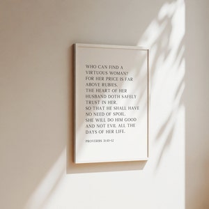 May include: A black and white printable wall art print with a quote from Proverbs 31:10-12. The quote reads: "Who can find a virtuous woman? For her price is far above rubies. The heart of her husband doth safely trust in her. So that he shall have no need of spoil. She will do him good and not evil all the days of her life."