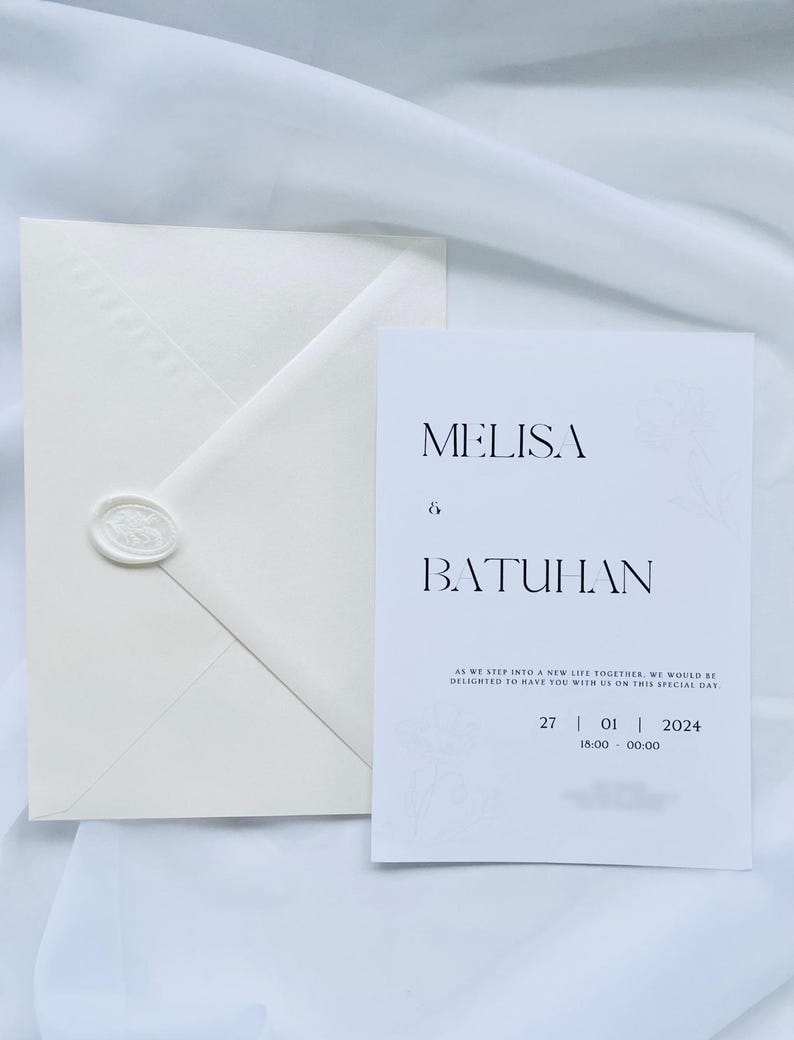 Puede incluir: Juego de invitaci&oacute;n de boda en color marfil, con un sobre sellado con un sello de cera. La tarjeta de invitaci&oacute;n presenta los nombres "MELISA & BATUHAN" y detalles del evento. Dise&ntilde;o minimalista y elegante, ideal para una boda.
