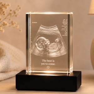 May include: A clear, rectangular crystal block illuminated from a black base. The block displays an ultrasound image of a fetus, with the text "The best is yet to come." and a heart symbol.