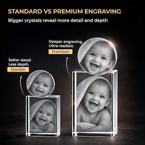 May include: Two rectangular glass blocks featuring laser-engraved portraits of a smiling baby wrapped in a towel. Text reads: STANDARD VS PREMIUM ENGRAVING, Bigger crystals reveal more detail and depth, Deeper engraving Ultra-realistic Premium, Softer detail Less depth Standar.