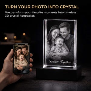 May include: A rectangular 3D crystal block featuring an engraved black and white family portrait of two adults and a child with the text Forever Together. The crystal sits on a black illuminated base, displayed next to a smartphone showing the same photo.