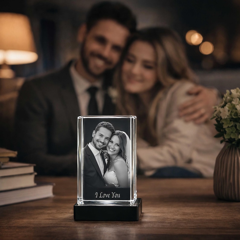 May include: A rectangular glass block featuring a laser-etched black and white photograph of a couple in formal attire. The glass sits on a black base and includes the engraved text I Love You at the bottom of the image within the glass.
