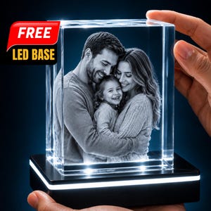 May include: A rectangular glass block featuring a laser-etched black and white photograph of a family of three embracing. The clear glass block sits on a black rectangular LED base with a white light strip. Text on the image reads FREE LED BASE.