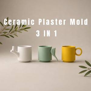 May include: Three ceramic mugs with distinct handles, labeled Ceramic Plaster Mold 3 IN 1. The left mug is white with a branch-like handle, the center is sage green with a curved handle, and the right is yellow with a circular handle.
