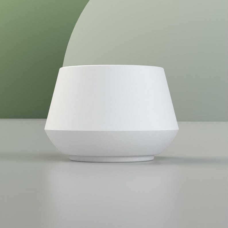 May include: A white ceramic planter with a wide, rounded base and a slightly flared top.