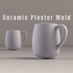 May include: Two white ceramic mugs with curved handles. The mugs have a smooth, matte finish and a rounded, oval shape. The text "Ceramic Plaster Mold" is displayed above the mugs.