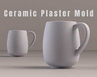 May include: Two white ceramic mugs with curved handles. The mugs have a smooth, matte finish and a rounded, oval shape. The text "Ceramic Plaster Mold" is displayed above the mugs.