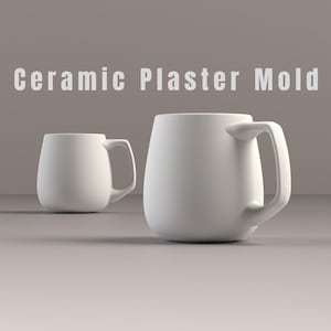 May include: Two white ceramic mugs with rounded bodies and large handles. The mugs are displayed on a neutral surface with the text "Ceramic Plaster Mold" in the background.