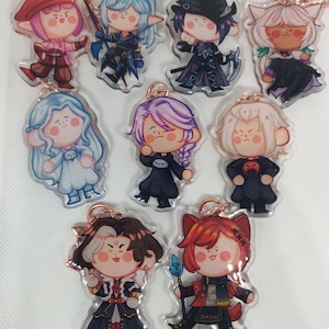 May include: A collection of cartoon character acrylic keychains. Each keychain features a unique character design with varying hair colors, outfits, and accessories. The keychains have a clear, glossy finish and are attached to a rose gold-colored keyring.