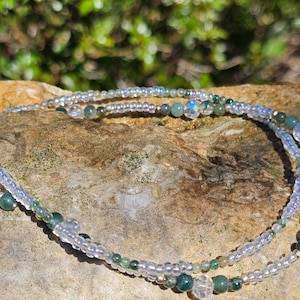 May include: A double-strand anklet with clear iridescent beads and green agate beads.