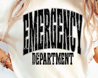 May include: Cream-colored t-shirt with the words "EMERGENCY DEPARTMENT" printed in large, distressed black letters. The text is arched at the top and straight at the bottom. The shirt is a casual style.