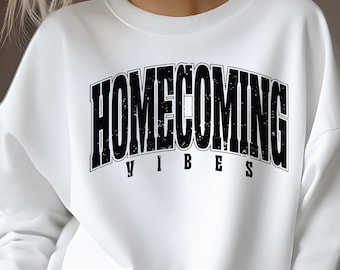 May include: White sweatshirt with black text that reads "HOMECOMING VIBES".