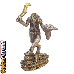 May include: A brass-coloured statue of a headless deity standing on a prostrate figure. The deity holds a curved sword in the right hand and a severed head in the left hand. The figure is adorned with intricate jewellery and stands on a lotus base.