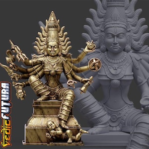 May include: A metallic gold-toned statue of a multi-armed deity seated on a rectangular pedestal, featuring intricate jewelry, a tall crown, and various symbolic objects in each hand. A small figure lies at the base. The text VEDIC FUTURA is visible.