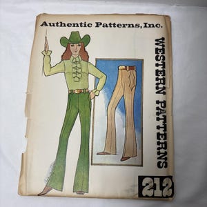 May include: Vintage sewing pattern titled "Authentic Patterns, Inc." featuring a Western theme. The cover illustration depicts a person in a green outfit with a cowboy hat and flared pants. The pattern includes a drawing of tan flared pants. The number "212" is visible.