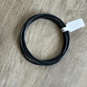 May include: A set of three ceramic mugs with a speckled, matte finish. The mugs are in shades of cream, light gray, and dark gray. Each mug has a simple, minimalist design and a rounded handle.