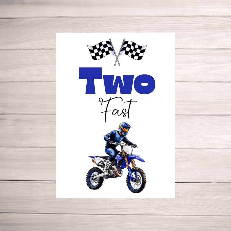 May include: A white card with blue text that says "Two Fast" and a black and white checkered flag. A blue and white dirt bike with a rider in a blue and white racing suit is in the bottom half of the card.