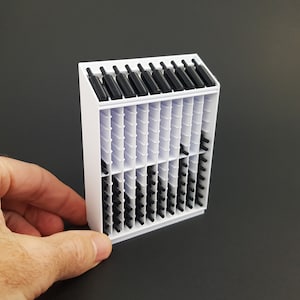 May include: White plastic wine rack with black plastic bottles. The rack has multiple shelves and is designed to hold a large number of bottles.
