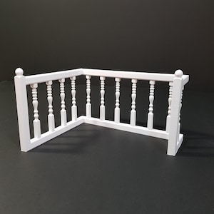 May include: White corner railing with decorative spindles. The railing is made of plastic and is approximately 12 inches tall.