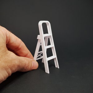 May include: A white plastic step ladder with three steps. The ladder is small and would be suitable for a child's playroom.