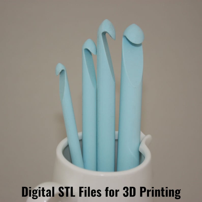 May include: Four light blue crochet hooks of different sizes are standing upright in a white ceramic mug.  Digital STL Files for 3D Printing.