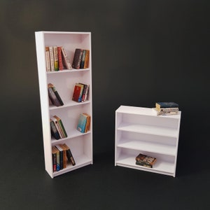 May include: Two white bookshelves with books on each shelf. The larger bookshelf has four shelves and the smaller bookshelf has two shelves.