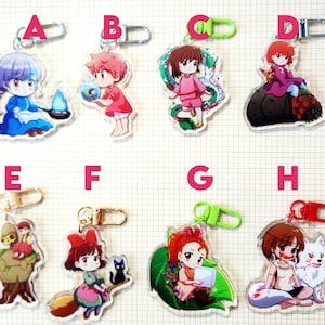 May include: A collection of eight acrylic keychains featuring anime-style characters. Each keychain has a different character design, with various colors and poses. The keychains have metal clasps for attachment.