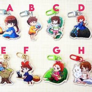 May include: Collection of anime-style acrylic keychains featuring various characters. Each keychain has a different character design, with vibrant colors and detailed artwork. The keychains have metal clasps for easy attachment to bags or keys.