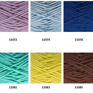 May include: A collection of ten skeins of yarn in various colors, including pink, purple, blue, turquoise, yellow, brown, and black. Each skein is labeled with a number, such as 11070, 11072, 11074, 11078, 11079, 11080, 11081, 11083, 11085, and 11086.