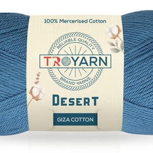 May include: A skein of blue 100% mercerized cotton yarn labeled "TROYARN" with the words "Reliable Quality" and "Brand Yarns" on the label. The yarn is labeled "Desert Giza Cotton".