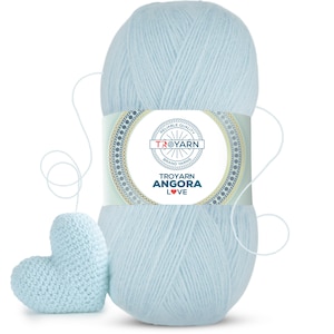 May include: A skein of light blue yarn with a label that reads "Troyarn Angora Love" and a small crocheted heart made from the yarn.
