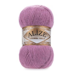 May include: A ball of pink Alize Angora Gold yarn. The yarn is soft and fluffy, and the label is gold with black text.