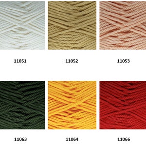 May include: A collection of yarn skeins in various colors, including white, beige, pink, green, yellow, red, and purple. Each skein is labeled with a number, such as 11050, 11051, 11052, 11053, 11058, 11060, 11063, 11064, 11066, and 11067.