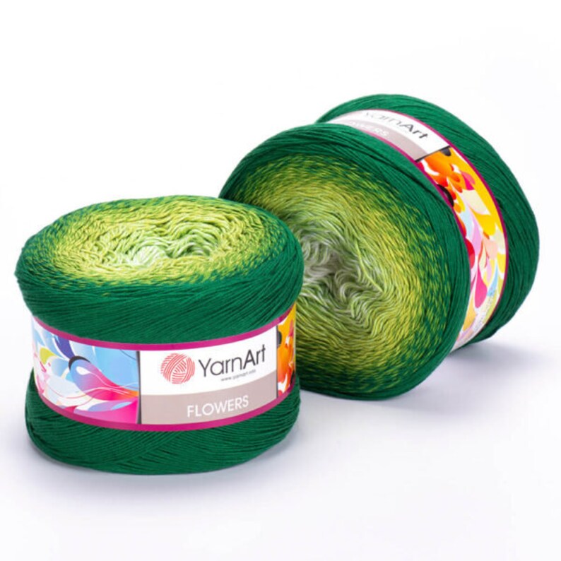 May include: Two skeins of green ombre yarn with a white and yellow gradient. The yarn is labeled "YarnArt Flowers".