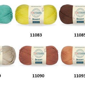 May include: Ten skeins of yarn in various colors, including turquoise, yellow, brown, red, beige, and peach. Each skein has a label that reads "Taiyarn Desert". The skeins are arranged in two rows of five, with the numbers 11080 through 11097 printed below each skein.