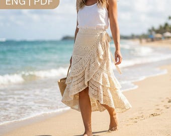 May include: A cream-colored, knee-length crochet wrap skirt featuring a tiered, ruffled design with intricate lace-like patterns. The skirt is paired with a simple white sleeveless top. The text ENG | PDF is visible in the upper left corner.