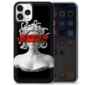 May include: A black phone case featuring a white Medusa sculpture design. The sculpture has a red stripe across the eyes. The phone case is compatible with an iPhone.