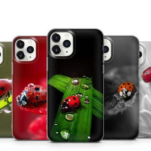 May include: Four different iPhone cases with a ladybug design. The cases are black, green, red, and white. Each case features a ladybug on a leaf, flower, or grass.