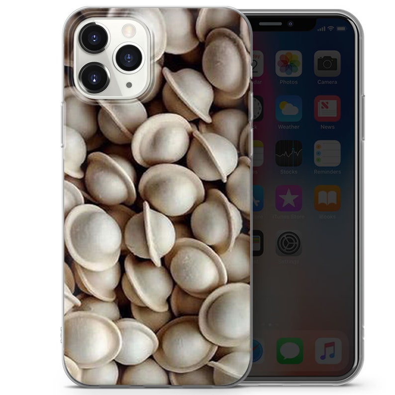 May include: A close-up image of a clear phone case featuring a design of numerous white dumplings. The dumplings are randomly arranged and cover the entire background of the case.