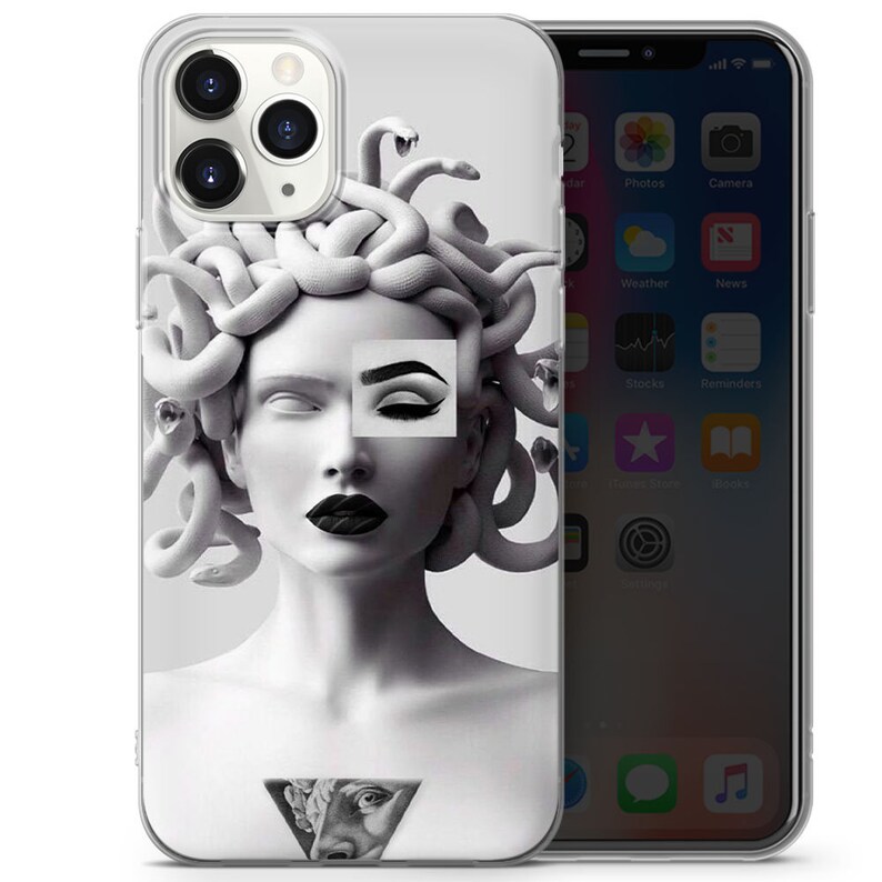 May include: A clear phone case featuring a black and white image of Medusa, a mythical Greek figure with snakes for hair. The image is styled with a modern, graphic design aesthetic.