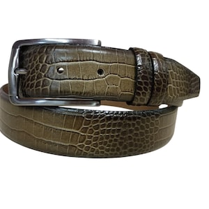 May include: A brown belt with a textured, crocodile-like pattern. The belt has a silver-colored rectangular buckle. The leather belt is a neutral color, suitable for various outfits. The belt is a classic accessory.