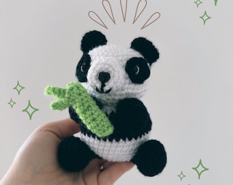 May include: A small, handmade crochet panda bear toy featuring a white and black yarn body, black ears, and black eye patches. The panda is holding a textured, light green crocheted bamboo stalk. The image includes brown line art above the panda's head and green star-shaped icons surrounding the figure.