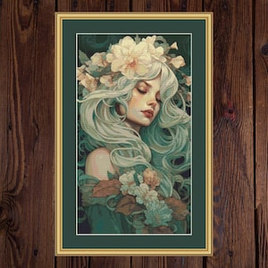 May include: A framed art print depicting a woman with long, flowing, pale green hair and a floral crown. The artwork has a soft, dreamlike quality, with a palette of greens, creams, and touches of red. The woman's eyes are closed, and she appears serene.