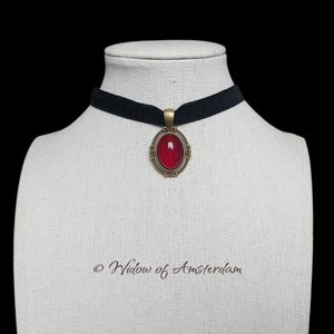Vampire choker necklace: Victorian Gothic pendant with deep blood-red glass on a black velvet ribbon.